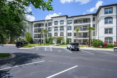 a parking lot in front of a large building at Brand New Modern Vista Cay Reserve Condo - 5008 in Orlando