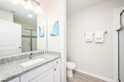 a bathroom with a sink and a toilet at Epic Universe Modern Vista Cay Condo - 5005 in Orlando