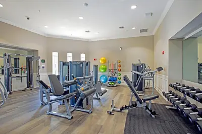 a gym with treadmills and machines in a room at New Modern Vista Cay Reserve Condo - 6003 in Orlando