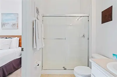a bathroom with a shower with a toilet and a sink at 2533 Renshaw Street in Orlando