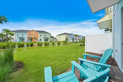 a pair of blue chairs on a patio with a yard at 3148 Caribbean Soul Drive in Orlando