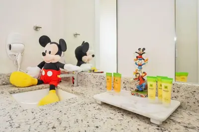 a bathroom with mickey mouse figurines on a counter at 3BD 3BA Themed House Near Disney in Orlando