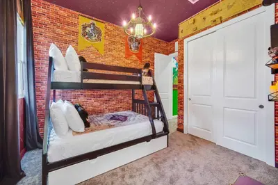a room with two bunk beds in a brick wall at 3BD 3BA Themed House Near Disney in Orlando