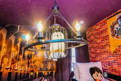 a chandelier hanging in a room with a brick wall at 3BD 3BA Themed House Near Disney in Orlando