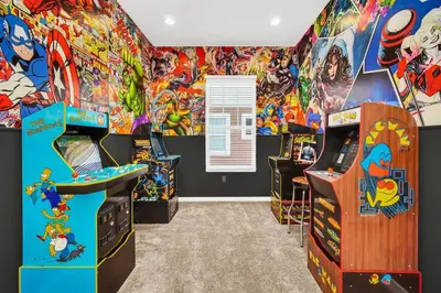 a room with a bunch of arcade games at 5 BD 5BA Themed House Near Disney in Orlando