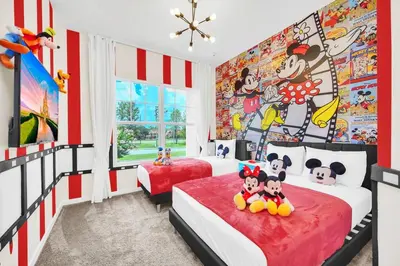 two beds in a bedroom with red and white stripes at 5 BD 5BA Themed House Near Disney in Orlando