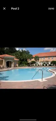 a picture of a large swimming pool with at Pool Private tub BBQ Mins to Disney and Universal in Kissimmee