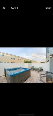 a large swimming pool on top of a building at Pool Private tub BBQ Mins to Disney and Universal in Kissimmee