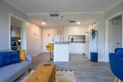 a living room with a couch and a kitchen at Cozy apt 2 bedrooms 1 mile Universal Studios in Orlando