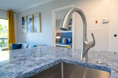 a kitchen with a granite counter top and a sink at Cozy apt 2 bedrooms 1 mile Universal Studios in Orlando