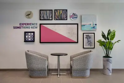 a waiting room with two chairs and a table at Home2 Suites By Hilton Sanford Orlando North in Sanford