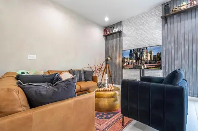a living room with a couch and two chairs at A Galaxy’s Edge Experience Awaits 5 Min to Disney in Orlando
