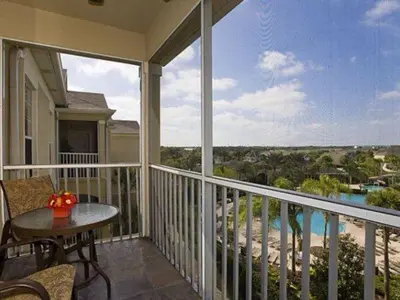 a balcony with a table and a view of the ocean at POOL VIEW 3 Bedroom Condo at Windsor Hills 'The Lido Deck' in Orlando