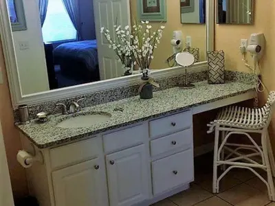 a bathroom with a sink and a large mirror at POOL VIEW 3 Bedroom Condo at Windsor Hills 'The Lido Deck' in Orlando
