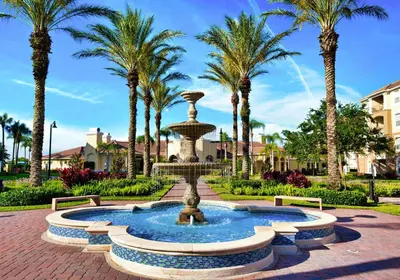 a fountain in a park with palm trees at The Epic Boca Penthouse Vista Cay Orlando in Orlando