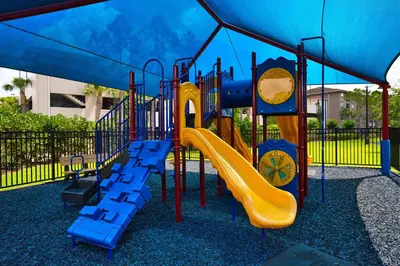a playground with a slide in a park at The Epic Boca Penthouse Vista Cay Orlando in Orlando
