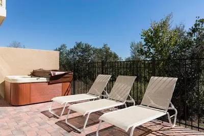 three chairs sitting on a patio with a grill at Cozy Beautiful 5 Suites close to Disney World in Orlando