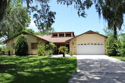 a house with a driveway and a garage at 3 Bed 2 Bath amazing Lakeview , Jacuzzi Bath Tub in Oviedo