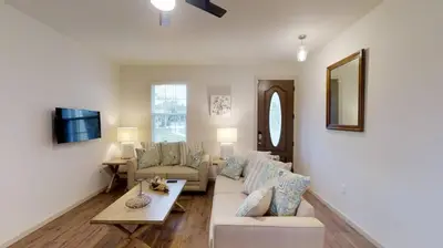 a living room with a couch and a table at Quiet 2 Bed Cottage in Oviedo w Resort Discounts in Oviedo