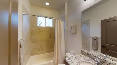 a bathroom with a shower and a sink and a tub at Quiet 2 Bed Cottage in Oviedo w Resort Discounts in Oviedo