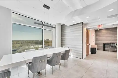 a dining room with a large white table and chairs at Lovely 2Bdrm 2Bath Thorton Park Condo with secure parking in Orlando