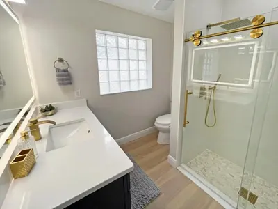 a bathroom with a shower and a sink and a toilet at Stardust Villa home in Kissimmee