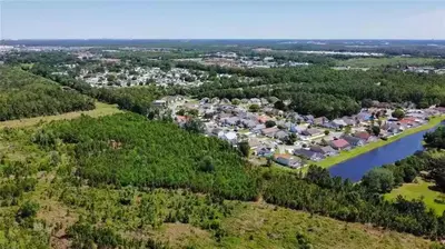 an aerial view of a subdivision of houses next to a river at Stardust Villa home in Kissimmee
