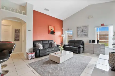a living room with a couch and a table at Stunning Home Near Disney World in Orlando
