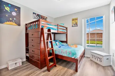 a bedroom with a bunk bed and a ladder at Stunning Home Near Disney World in Orlando