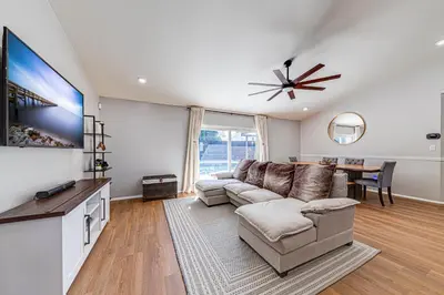 a living room with a couch and a table at Beautiful home, centrally located to Parks with Pool in Orlando