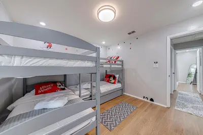 a bunk bed room with two bunk beds in it at Beautiful home, centrally located to Parks with Pool in Orlando