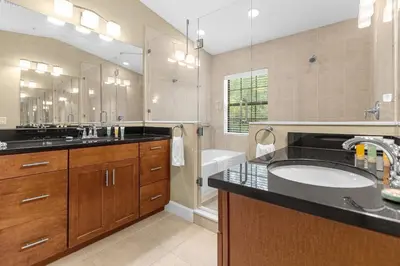 a bathroom with a sink and a large mirror at Vibrant 4BR Family Townhome 1 mile from Disney World and Disney Springs in Orlando