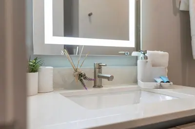 a bathroom sink with a faucet and a mirror at Amazing 4 Bedrooms Next to DisneyPrivate Pool in Orlando