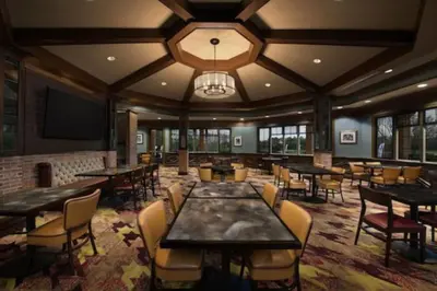 a restaurant with tables and chairs and a flat screen tv at Marriott Grande Vista Luxury 1BD villa sleeps 4 in Orlando