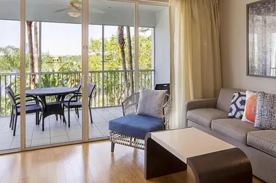 a living room with a couch and a table at Take the Family to Orlando in this great 2BD in a resort setting with tons of amenities in Orlando