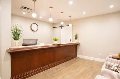a waiting room with a reception desk and a laptop at Take the Family to Orlando in this great 2BD in a resort setting with tons of amenities in Orlando
