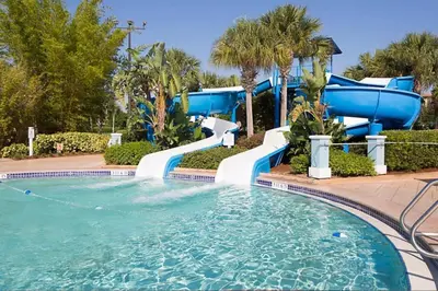 a water slide in a pool at a resort at Take the Family to Orlando in this great 2BD in a resort setting with tons of amenities in Orlando