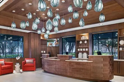 a lobby with a bar with red chairs and lights at Relax after the Orlando parks in this 1BD resort condo with pools, restaurants, activities etc in Orlando