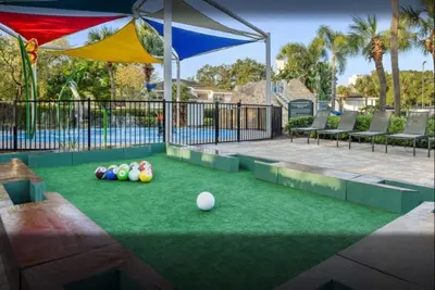a backyard with a lawn with balls on it at Relax after the Orlando parks in this 1BD resort condo with pools, restaurants, activities etc in Orlando