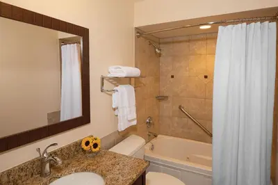 a bathroom with a sink and a tub and a shower at Have fun in this 2BD condo in a resort setting with close access to Orlando parks in Orlando