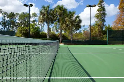 a tennis net on a tennis court at Relax after enjoying all the parks Orlando has to offer in this 1BD vacation condo in Orlando