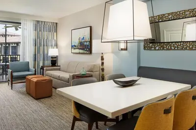 a living room with a table and chairs at Relax after enjoying all the parks Orlando has to offer in this 1BD vacation condo in Orlando