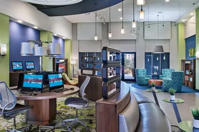 a lobby with a desk with two computers and chairs at Family fun in this 2BD condo with multiple pools, mini golf, restaurants etc onsite in Orlando