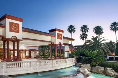 a house with a swimming pool and palm trees at Family fun in this 2BD condo with multiple pools, mini golf, restaurants etc onsite in Orlando