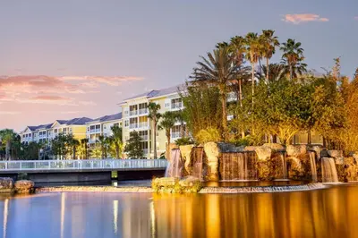 a view of a resort with a body of water at Family fun in this 2BD condo with multiple pools, mini golf, restaurants etc onsite in Orlando