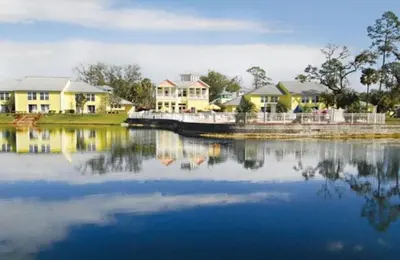 a large body of water with houses and a boat at Diamond Barefootn Resort 2BD in Orlando
