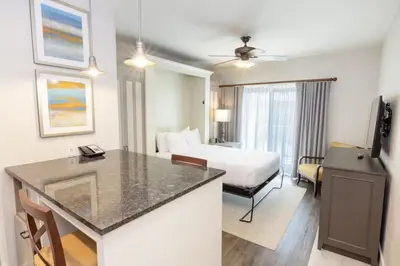 a hotel room with a king sized bed and a kitchen at WorldMark Kingstown Reef - 1BD Sleeps up to 4 in Orlando