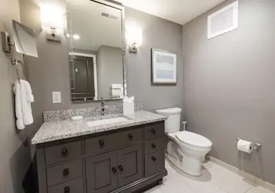 a bathroom with a sink and a toilet and a mirror at WorldMark Kingstown Reef - 1BD Sleeps up to 4 in Orlando