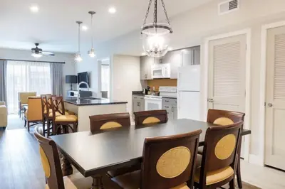 a kitchen and dining room with a table and chairs at WorldMark Kingstown Reef - 2BD Sleeps up to 6 in Orlando