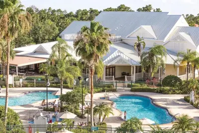 an aerial view of a resort with a pool and palm trees at WorldMark Kingstown Reef - 2BD Sleeps up to 6 in Orlando